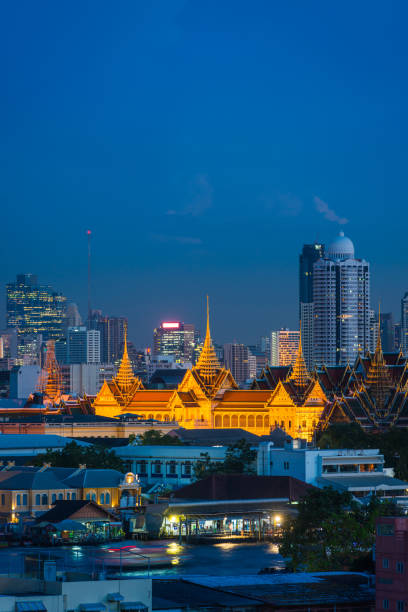 istock Bangkok palace illuminated at dusk between river and skyscrapers Thailand 1136598815