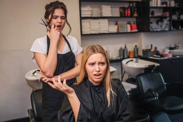 Angry female client in beauty salon. Blonde young woman screaming at hairdresser, fight in hairdresser salon Angry female client in beauty salon. Blonde young woman screaming at hairdresser. Badly hairstyle in hairdresser salon angry hairstylist stock pictures, royalty-free photos & images
