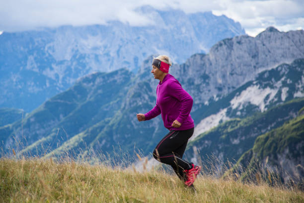 istock Senior woman running in mountains 1136600922