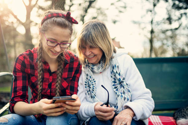 Granddaughter helping her grandmother with smartphone setup Grandmother just got a new smartphone. Her teenage granddaughter is helping her to set up the phone.
Nikon D810 teenage girl with grandmother stock pictures, royalty-free photos & images