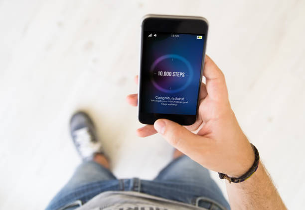istock male hand 10000 steps smart phone 1136603508