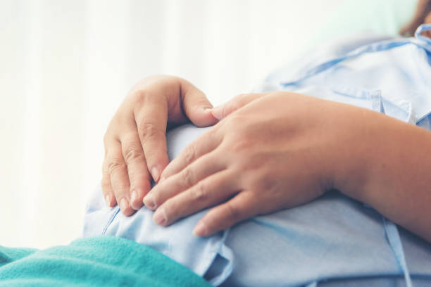 Pregnant woman lying on the bed waiting to give birth in a hospital. stock photo