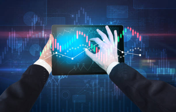 istock Hand holding tablet with global reports and stock market change concept 1136608506