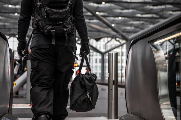 istock Dark hooded  figure in empty urban surroundings 1136608950