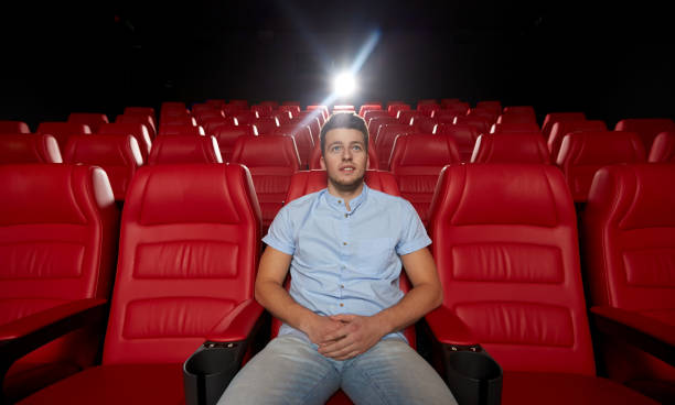 istock happy young man watching movie in theater 1136610498