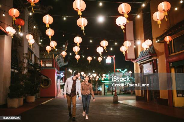 Happy Couple Exploring Chinatown In Downtown Los Angeles At Night Stock Photo - Download Image Now