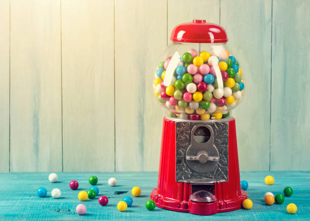 Carousel Gumball Machine Bank Carousel Gumball Machine Bank on a wooden background gumball machine stock pictures, royalty-free photos & images