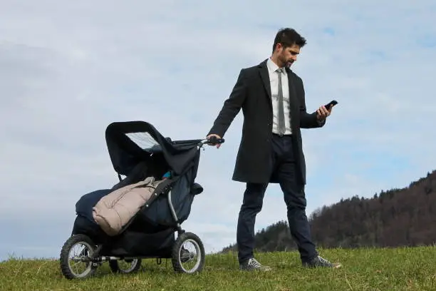 Photo of Father with Stroller and Smartphone