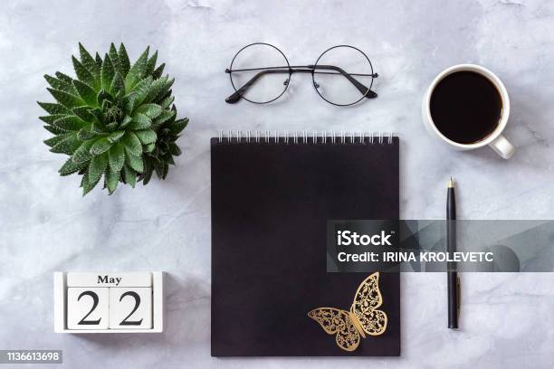 Office Or Home Table Desk Wooden Cubes Calendar May 22 Black Notepad Cup Of Coffee Succulent Glasses On Marble Background Concept Stylish Workplace Flat Lay Top View Stock Photo - Download Image Now