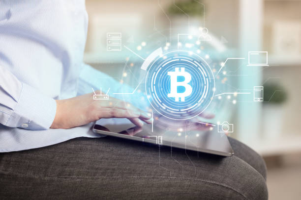 istock Business woman using tablet in home office mood with bitcoin link network concept 1136615480