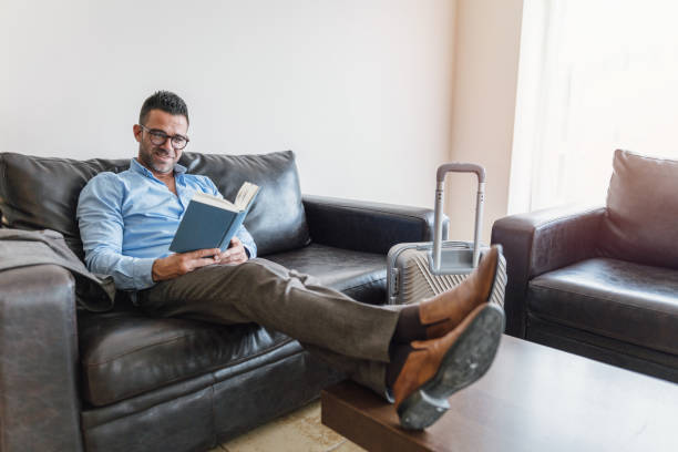 istock Businessman reading book at the sofa 1136616966