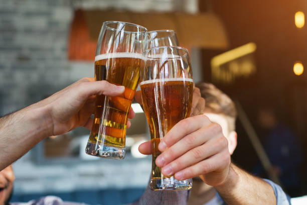 istock Male friends drinking beer and clinking glasses 1136617603
