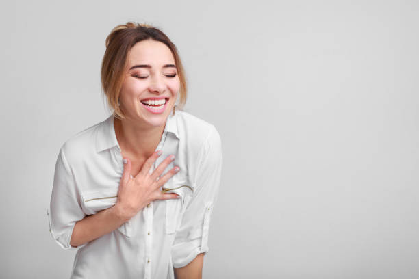 istock Delightful girl laughing with hands on chest 1136621088