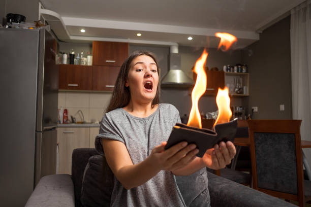 Young Woman Holding A Wallet Wallet On Fire Surprised Girl Magic Concept Focus Wallet Is Burning Fire Stock Photo - Download Image Now - iStock
