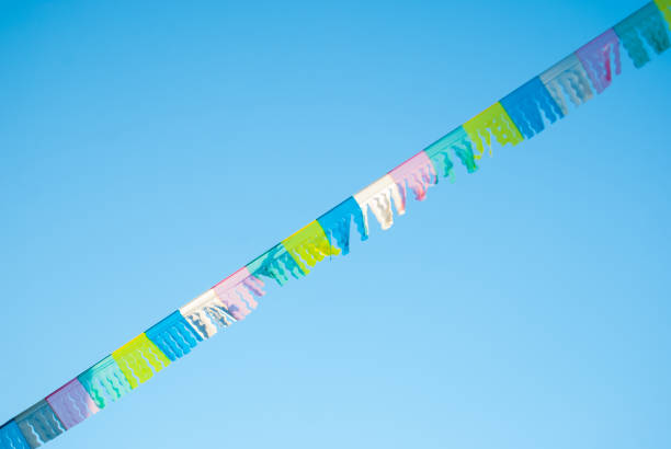 Single rope with coloreful flags in the blue sky