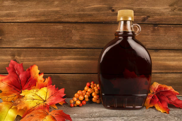 Maple syrup bottle on a wooden plank background.