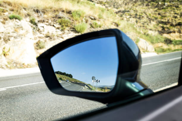 istock rural highway reflected in the glass of a car mirror 1136624971