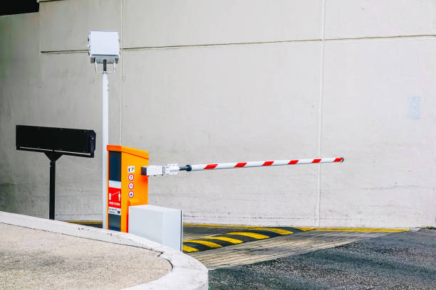 istock Car park barrier, Security system for building access - barrier gate stop with traffic cones and cctv 1136626377