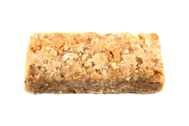 istock Caramel ground peanuts bar isolated on white background. Caramel peanut powder candy bar isolated 1136627187