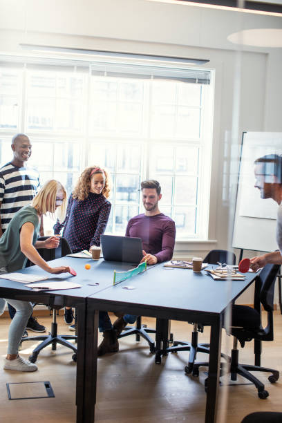 istock Young designers having fun playing table tennis in an office 1136627679