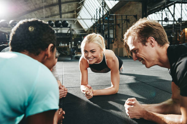 istock Gym friends smiling and planking together during a workout class 1136628085