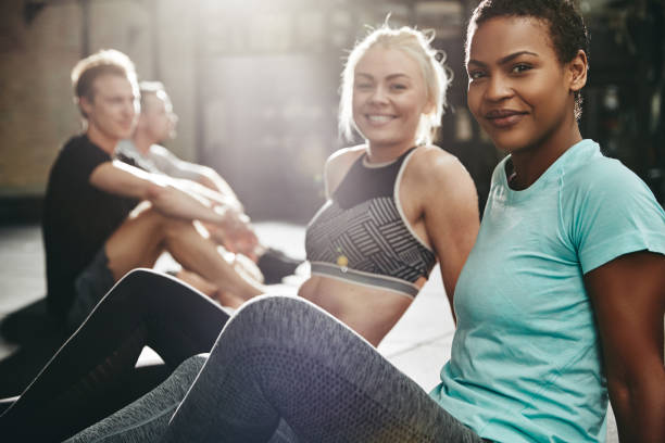 istock Smiling women sitting on a gym floor after working out 1136628168