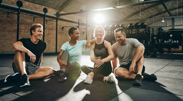 istock Laughing friends sitting and talking together after a gym workout 1136628550