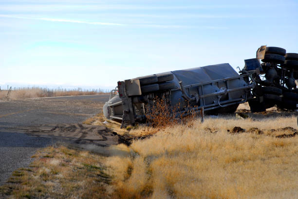 Car wreck of semi truck trailer rolled over crash crashed wrecked rollover stock photo