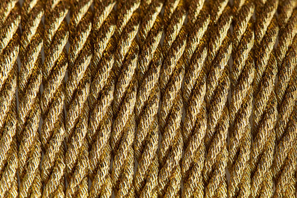 istock Background texture of gold twisted rope close-up. 1136629621