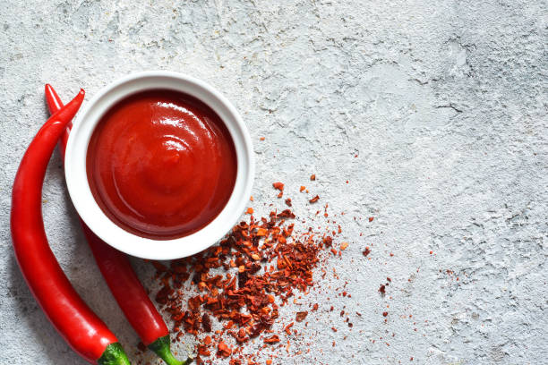 istock Spicy chili sauce with spices on a concrete background. View from above. 1136629719