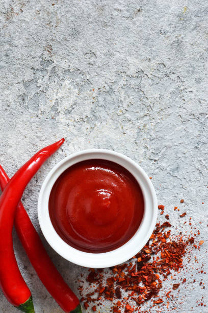 istock Spicy chili sauce with spices on a concrete background. View from above. 1136629803
