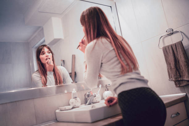 istock Fashionable Female Fixing Makeup In Bathroom 1136630041