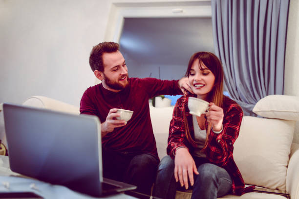 istock Couple Watching A Movie And Drinking Tea 1136630062