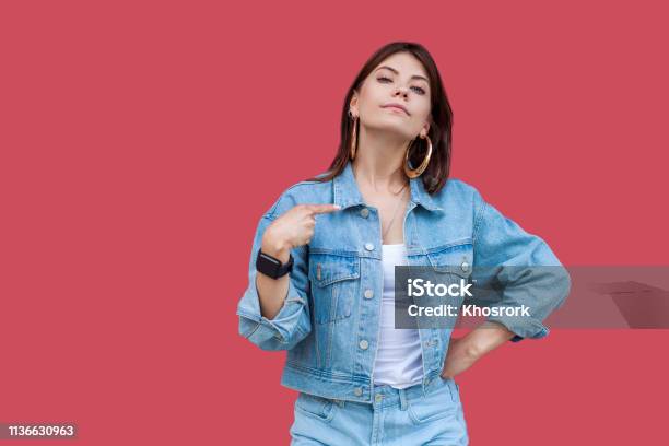 Portrait Of Proud Beautiful Brunette Young Woman With Makeup In Denim Casual Style Standing Pointing Herself And Looking At Camera With Haughty Face Stock Photo - Download Image Now