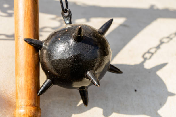 Morning Star, a medieval weapon made of a heavy iron ball with spikes, which is attached to a wooden stick by a chain Morning Star, a medieval weapon made of a heavy iron ball with spikes, which is attached to a wooden stick by a chain, strong medieval restraints stock pictures, royalty-free photos & images