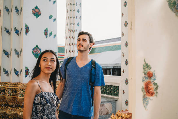 istock Young couple exploring a temple in Bangkok 1136632371