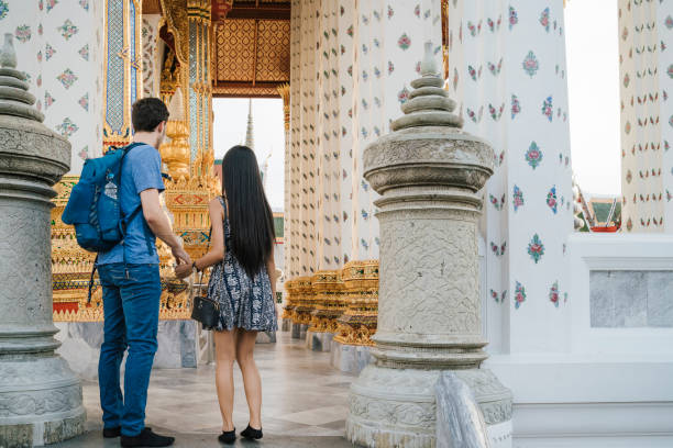 istock Young couple exploring a temple in Bangkok 1136632372