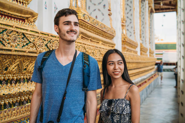 istock Young couple exploring a temple in Bangkok 1136632374
