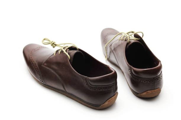 Black leather dress shoes feature a classic design with laces and stitching, perfect for formal events like weddings or business meetings.