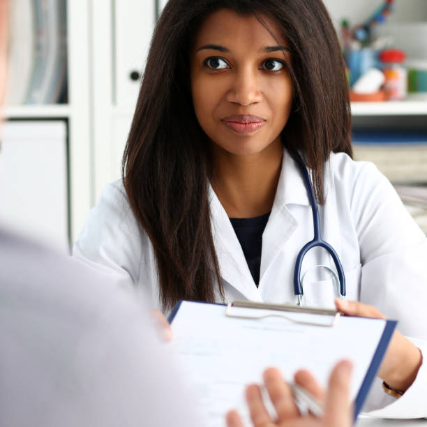 istock Female doctor hand hold silver pen and showing 1136633944