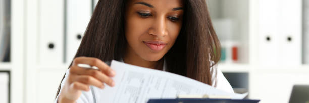 istock Beautiful black smiling female doctor hold 1136633953