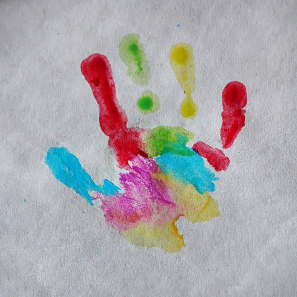 istock Child's colorful palm print on craft paper. Square. 1136634197