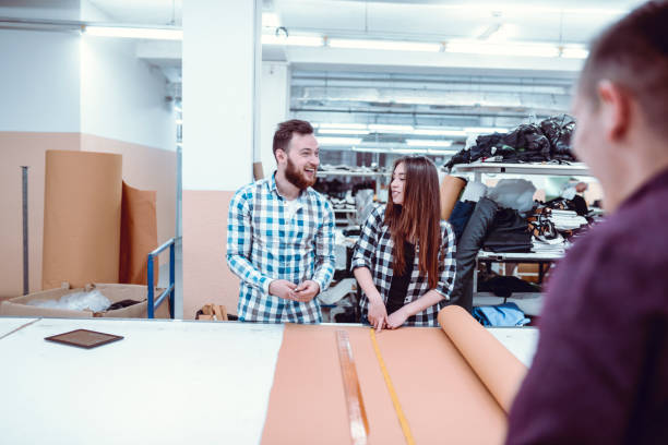 istock Senior Worker Helping Employees In Textile Factory 1136634200