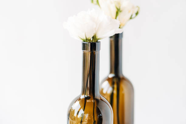 istock light bouquet in bottles.minimal composition of beautiful white flowers.copy space.white background. 1136634418