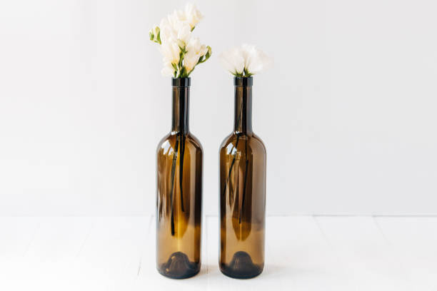 minimal composition of beautiful white flowers in bottles.copy space.white background.