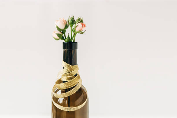 istock Creative floral composition with roses in bottle.Minimal concept.White background.Copy space 1136634455