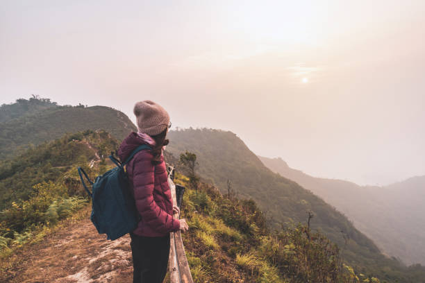 istock Young woman traveler looking at sunset over the mountain 1136634607
