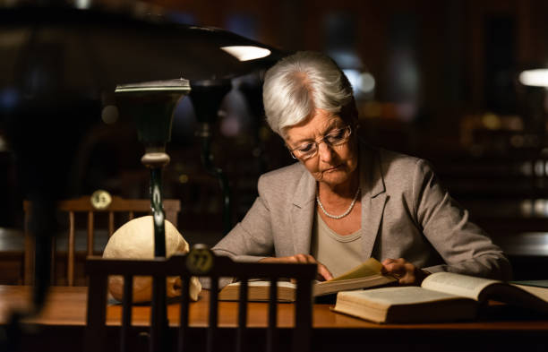 istock Senior Female Professor In Old Library 1136636034