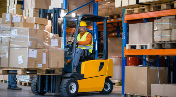 warehouse worker with forklift - empilhadora imagens e fotografias de stock