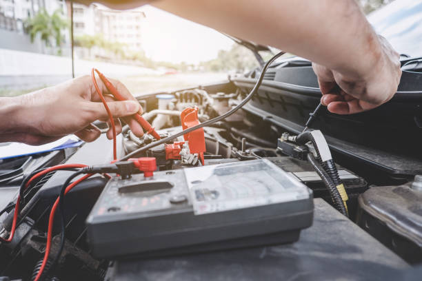 istock Services car engine machine concept, Automobile mechanic repairman hands checking a car engine automotive workshop with digital multimeter testing battery, car service and maintenance 1136637520